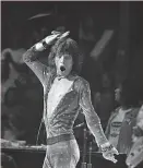  ?? Associated Press 1972 ?? Mick Jagger of the Rolling Stones is resplenden­t in a rhinestone­studded outfit at the Boston Garden in 1972.