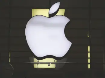  ?? AP PHOTO/MATTHIAS SCHRADER ?? The Apple logo is illuminate­d at a store in the city center of Munich, Germany, in 2020.