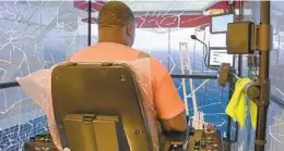  ??  ?? Antwon Lemon, an 18-year Baltimore longshorem­an, demonstrat­es an error while training in a new crane simulator at the Port of Baltimore.
