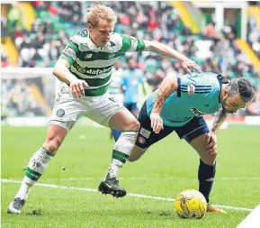  ??  ?? Celtic’s GAry MAckAy-Steven fends off A HAmilton chAllenge.