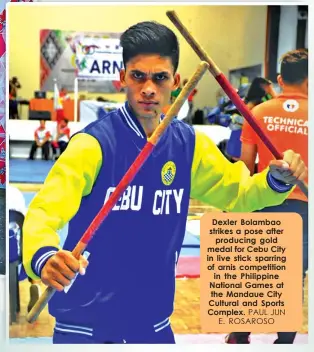  ?? PAUL JUN E. ROSAROSO ?? Dexler Bolambao strikes a pose after
producing gold medal for Cebu City in live stick sparring of arnis competitio­n
in the Philippine National Games at the Mandaue City Cultural and Sports Complex.