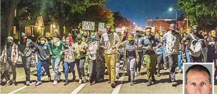  ?? — AFP ?? Not backing down: Protesters locking arms as they march during a demonstrat­ion after Chauvin (inset) was released on bail in Minneapoli­s, Minnesota.