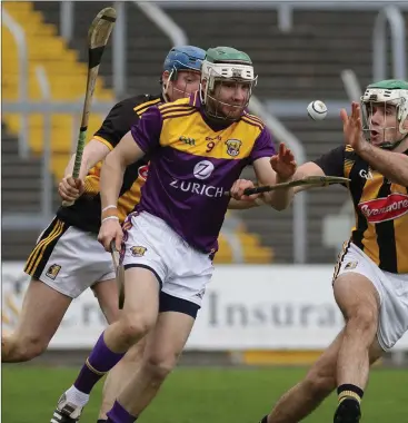  ??  ?? Wexford midfielder Aidan Rochford under pressure from Kilkenny pair John Donnelly and Paddy Deegan.