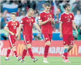  ??  ?? Russian players walk off the pitch at the end of the match against Portugal.