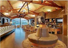  ??  ?? Schist walls and exposed wooden beams dominate the lobby.