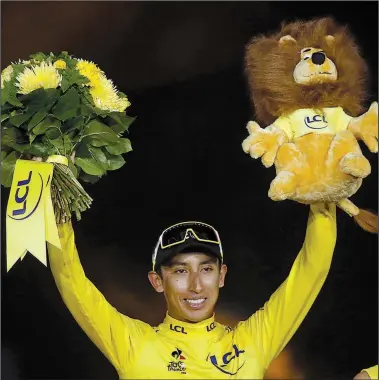  ?? AP/MICHEL EULER ?? ABOVE Colombia’s Egan Bernal stands on the podium in Paris after winning the Tour de France on Sunday. Bernal, 22, is the race’s youngest post-World War II champion and its first from South America. “I am the most happy guy in the world,” Bernal said. “I just won the Tour de France, and, yeah, I can’t believe it.”