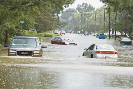  ?? STAFF ?? Flooding is a recurring problem in Hampton Roads. In this 2019 photo, vehicles are stuck in Newport News.