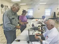  ?? BY JOHN MCCASLIN ?? Washington residents Wendy Murdoch and Bradley Schneider, the latter a member of the Washington Town Council, cast votes Tuesday in the Virginia House of Delegates District 18 Democratic primary at the Washington Volunteer Fire and Rescue polling station.