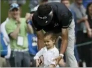  ?? DAVID J. PHILLIP — THE ASSOCIATED PRESS ?? Bubba Watson helps his daughter Dakota putt during the par three competitio­n at the Masters golf tournament Wednesday in Augusta, Ga.