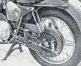  ??  ?? This close-up shows the Royal Enfield’s distinctiv­e rear chaincase, one of the two chain-tensioner cams and the retracted prop stand. Mortons Motorcycle Archive photo.