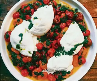  ?? Katie Workman / Associated Press ?? Roasting the cherry tomatoes — any color will work — brings out the natural sweetness.