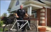  ?? RICHARD PAYERCHIN — THE MORNING JOURNAL ?? Avon Police Patrolman David Layne stands with a department police bicycle outside the police station, 36146 Detroit Road, Avon.