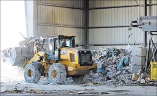  ?? RONDA CHURCHILL/LAS VEGAS REVIEW-JOURNAL ?? A worker uses a front-end loader Monday in the materials recovery facility at Lunas Recycling. The family-owned waste management facility has an agreement with Republic Service to dump waste at Republic’s Apex landfill, but found out Republic charges...