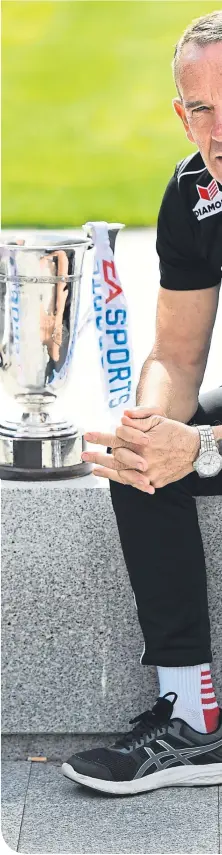  ??  ?? Kenny Shiels with the League of Ireland Cup and (inset) receiving an embrace from son, Dean, after Kilmarnock had beaten Celtic in the 2012 League Cup Final