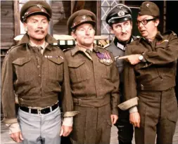  ??  ?? The army game: Ernie, Eric and Sir John Mills attempt to escape the clutches of POW camp Stalag 54 and German commandant Arnold Diamond in a 1971 sketch