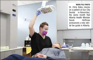  ?? NEWS FILE PHOTO ?? Dr. Chris Baba checks on a patient at Sun City Dental in November, the same month that Alberta Health Minister Sarah Hoffman announced a new dental fee guide in Alberta.