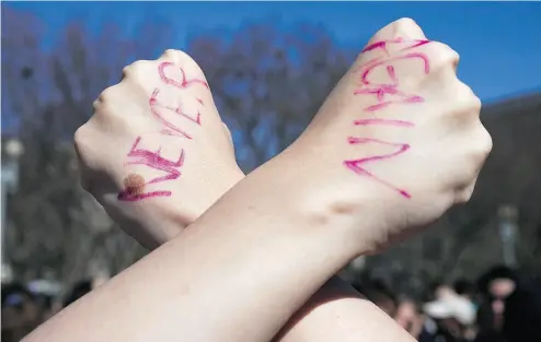  ?? MANDEL NGAN / AFP / GETTY IMAGES ?? A student displays a message written on her hands as high school students from the District of Columbia, Maryland and Virginia staged walkouts and gathered in front of the White House Feb. 21 in support of gun control.