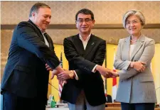  ??  ?? US Secretary of State Mike Pompeo, Japan’s Foreign Minister Taro Kono and South Korea’s Foreign Minister Kang Kyung Wha shake hands at a meeting in Tokyo
