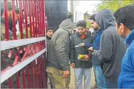  ?? PTI ?? A police officer checks ID cards of students at the National Institute of Technology in Srinagar on Wednesday.