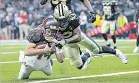  ?? WESLEY HITT GETTY IMAGES ?? Ryan Fitzpatric­k of the Tampa Bay Buccaneers runs the ball for a touchdown as Marcus Williams of the Saints tries to tackle him Sunday in New Orleans. The Bucs won, 48-40.