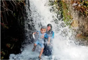  ?? AFP ?? Arab-Israelis enjoy spring water in Tabgha, on the shores on the Sea of Galilee, northern Israel. —