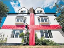  ??  ?? National pride: While once the country was indifferen­t about the tournament, now houses – such as this one in in Ashbourne, Derbyshire – are being draped in the flag of St George