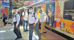  ??  ?? ■ Passengers deboard a local train at Mumbai’s Kurla station as the suburban network resumed operations after 84 days only for essential workers to commute to work.