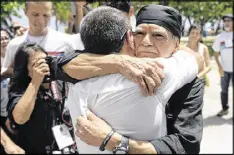  ?? CARLOS GIUSTI / ASSOCIATED PRESS ?? Puerto Rican nationalis­t Oscar Lopez Rivera embraces a supporter on El Escambron Beach in San Juan on Wednesday, shortly after his release from custody. Lopez was considered a leader of the Armed Forces of National Liberation, or FALN.