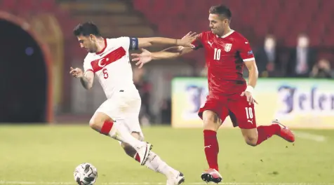  ??  ?? Turkey’s Ozan Tufan dribbles past Serbia’s Dusan Tadic during a UEFA Nations League match in Belgrade, Serbia, Sept. 6, 2020.