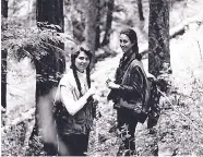  ?? COURTESY OF LAURA MCCARTHY ?? Laura McCarthy, right, and Terry Johnson in 1985 pause while taking tree measuremen­ts for the U.S. Forest Service in the Idaho Panhandle National Forest.