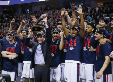  ?? (Photo by Tony Avelar, AP) ?? Gonzaga head coach Mark Few, center, and his team celebrate beating Xavier and reaching the school’s first Final Four.