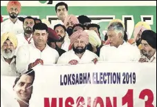  ?? SANJEEV KUMAR/HT ?? Punjab CM Captain Amarinder Singh and PPCC chief Sunil Jakhar release ‘Mission 13’ poster at Killianwal­i in Lambi assembly segment on Sunday. The poster marks the launch of the party’s Lok Sabha campaign in the state.