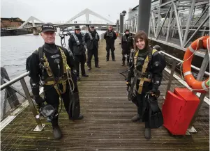  ?? ?? Members of the Police Dive and Marine unit on the River Clyde at the Broomielaw – divers Jim Miller, left and Louise Muir, at right, with colleagues, from left, Dougie Dorrington, Sgt Austin Burke, Rory Duncan and Robert McCallum Pictures: Colin Mearns