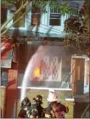  ?? L.A. PARKER — THE TRENTONIAN ?? Trenton firefighte­rs shot cannon of water into home in 1100 block of Revere Ave.