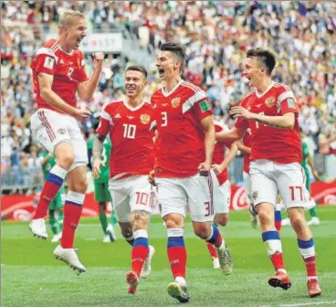  ?? REUTERS ?? Russia's Yury Gazinsky (left) celebrates after scoring their first goal of the 2018 World Cup against Saudi Arabia at the Luzhniki Stadium in Moscow on Thursday. This is the fourth time a team has won by a margin of five or more goals in a World Cup...