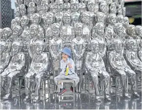  ?? AFP ?? A boy sits on a chair among sculptures on display at a shopping centre in Beijing in June last year. China’s population shrank in 2022 for the first time in more than six decades, official data released on Tuesday revealed.