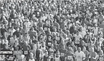  ?? — AP ?? Runners start during the “GutsMuths Rennsteigl­auf” cross- country race, one of Europe’s most popular races, at Neuhaus am Rennweg, central Germany, on Saturday. The GutsMuths run gathered more than 15,000 runners from 23 countries this year.