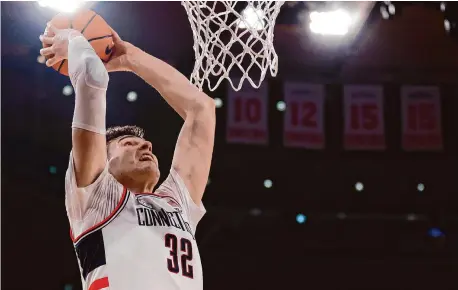  ?? Sarah Stier/Getty Images ?? UConn’s Donovan Clingan dunks during Thursday’s win over Xavier in the Big East quarterfin­als at Madison Square Garden.