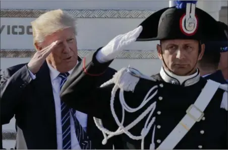  ?? ANDREW MEDICHINI — THE ASSOCIATED PRESS ?? President Donald Trump salutes a Carabinier­i paramilita­ry officer upon his arrival at Fiumicino’s Leonardo Da Vinci Internatio­nal airport, near Rome, Tuesday.