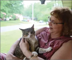 ?? (Special to the Democrat-Gazette/Dwain Hebda) ?? “There is peace in your heart when you know you have somehow tamed the chaos.” Elizabeth Reha takes a moment to relax with her cat, George.