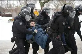  ?? THE ASSOCIATED PRESS ?? Police in St. Petersburg, Russia, detain a man trying to lay flowers to honor Alexei Navalny at a monument to victims of Soviet repression last month.