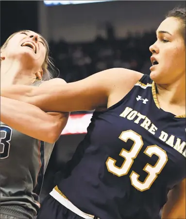  ?? Jessica Hill / AP ?? Notre Dame’s Kathryn Westbeld, right, closely defends UConn’s Katie Lou Samuelson on Dec. 3 in Hartford.