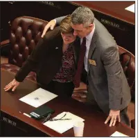  ?? Arkansas Democrat-Gazette/STATON BREIDENTHA­L ?? Rep. LeAnne Burch (left), D-Monticello, and Rep. John Maddox, R-Mena, greet each other Monday in the House chamber at the state Capitol before the start of the fiscal session.