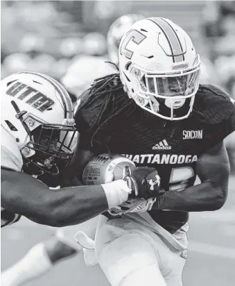  ?? PHOTO BY MARK GILLILAND ?? UTC’s Richardre Bagley tries to break a tackle by UT-Martin’s Demonta Daniel during a game Sept. 16 at Finley Stadium.