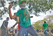  ?? AP PHOTO/ARIANA CUBILLOS ?? Masked anti-government protesters face off with security forces in Caracas, Venezuela, on Wednesday.