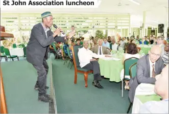  ??  ?? Calypsonia­n, Young Bill Rogers (left) entertaini­ng attendees yesterday at the St. John Associatio­n Guyana annual luncheon at the Baridi Benab at State House. President David Granger (left of the singer) pays keen attention. (Ministry of the Presidency photo)