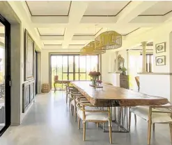  ?? ?? The coffered ceiling defines the dining area, furnished with a dao dining table and bamboo lighting fixtures.