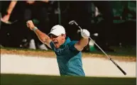  ?? Matt Slocum / Associated Press ?? Rory McIlroy, of Northern Ireland, reacts after holing out from the bunker for a birdie during the final round at the Masters on April 10 in Augusta, Ga.