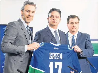  ?? CP PHOTO ?? In this April 26 file photo, Vancouver Canucks president Trevor Linden, left, and general manager Jim Benning, right, introduce the Canucks new head coach Travis Green during a news conference in Vancouver, B.C.