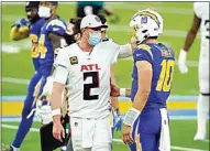  ?? ASHLEY LANDIS / AP ?? Los Angeles Chargers quarterbac­k Justin Herbert (10) talks with Atlanta Falcons quarterbac­k Matt Ryan (2) at the end of Sunday’s game in Inglewood.